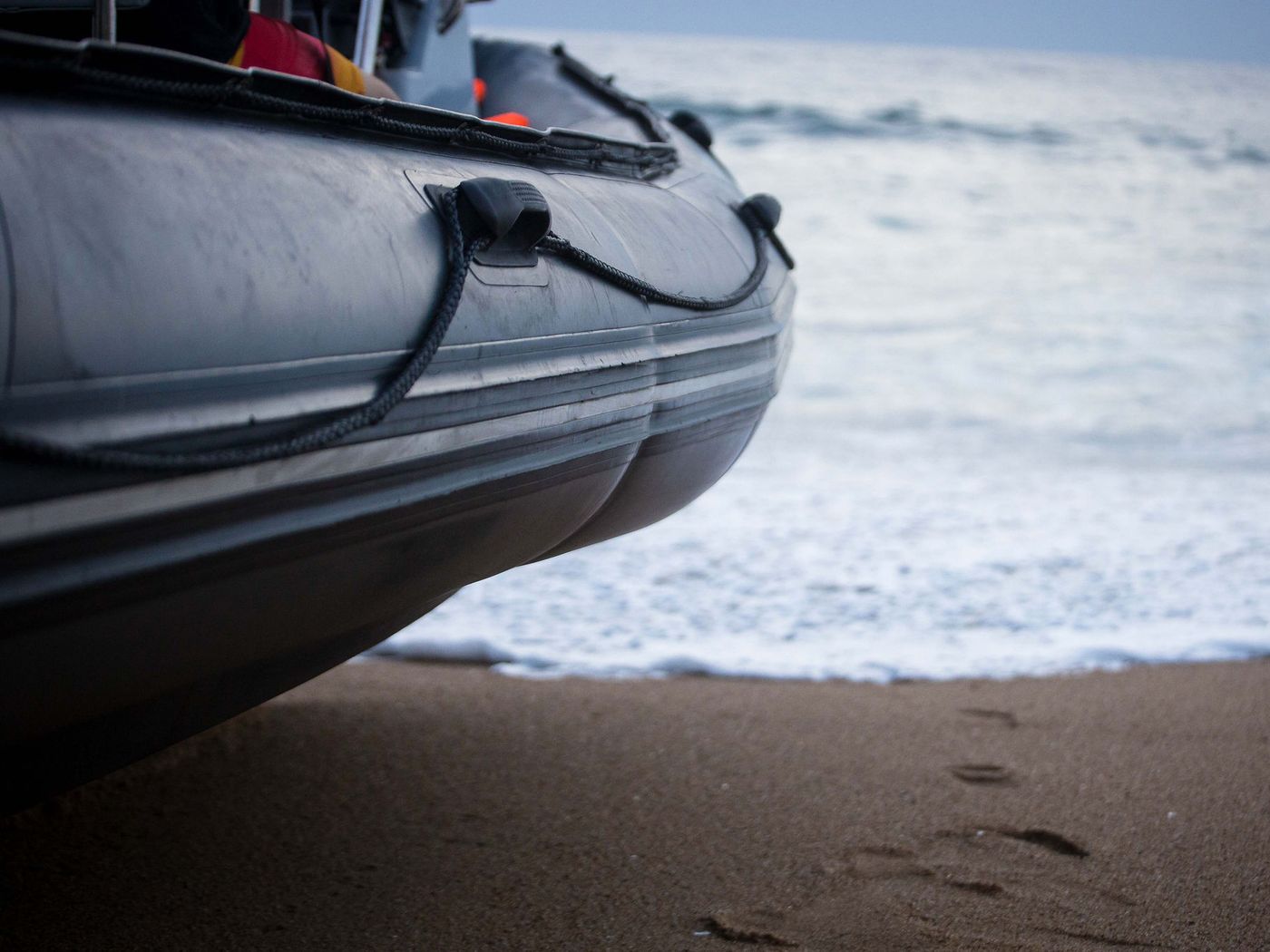 Close-up of a grey pontoon and grab lines on a rigid inflatable boat parked on the beach